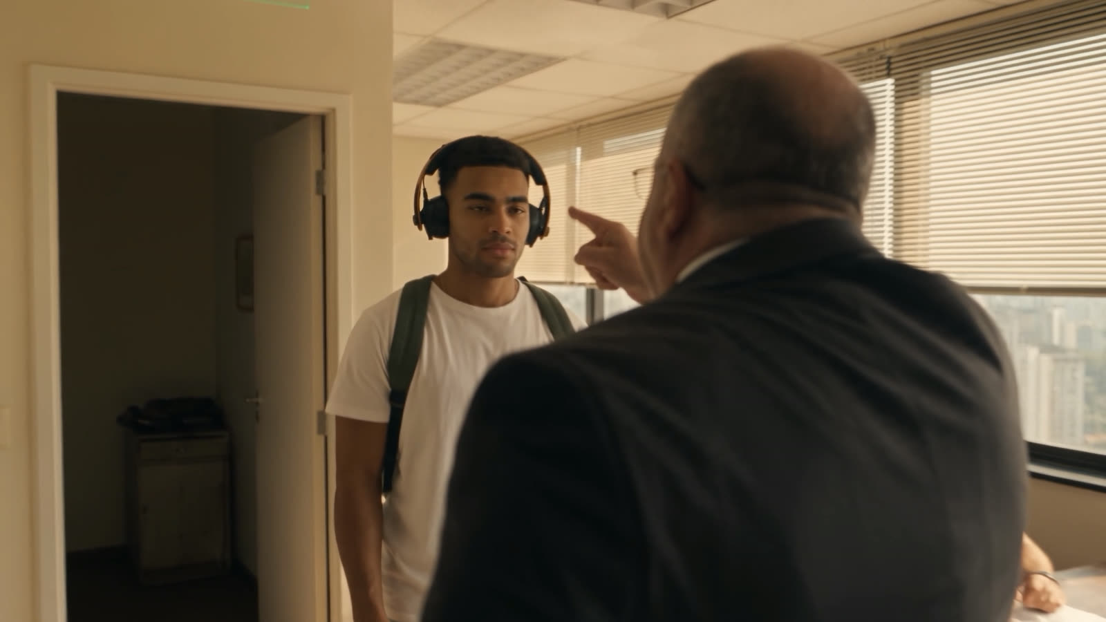 He walks in and faces the boss