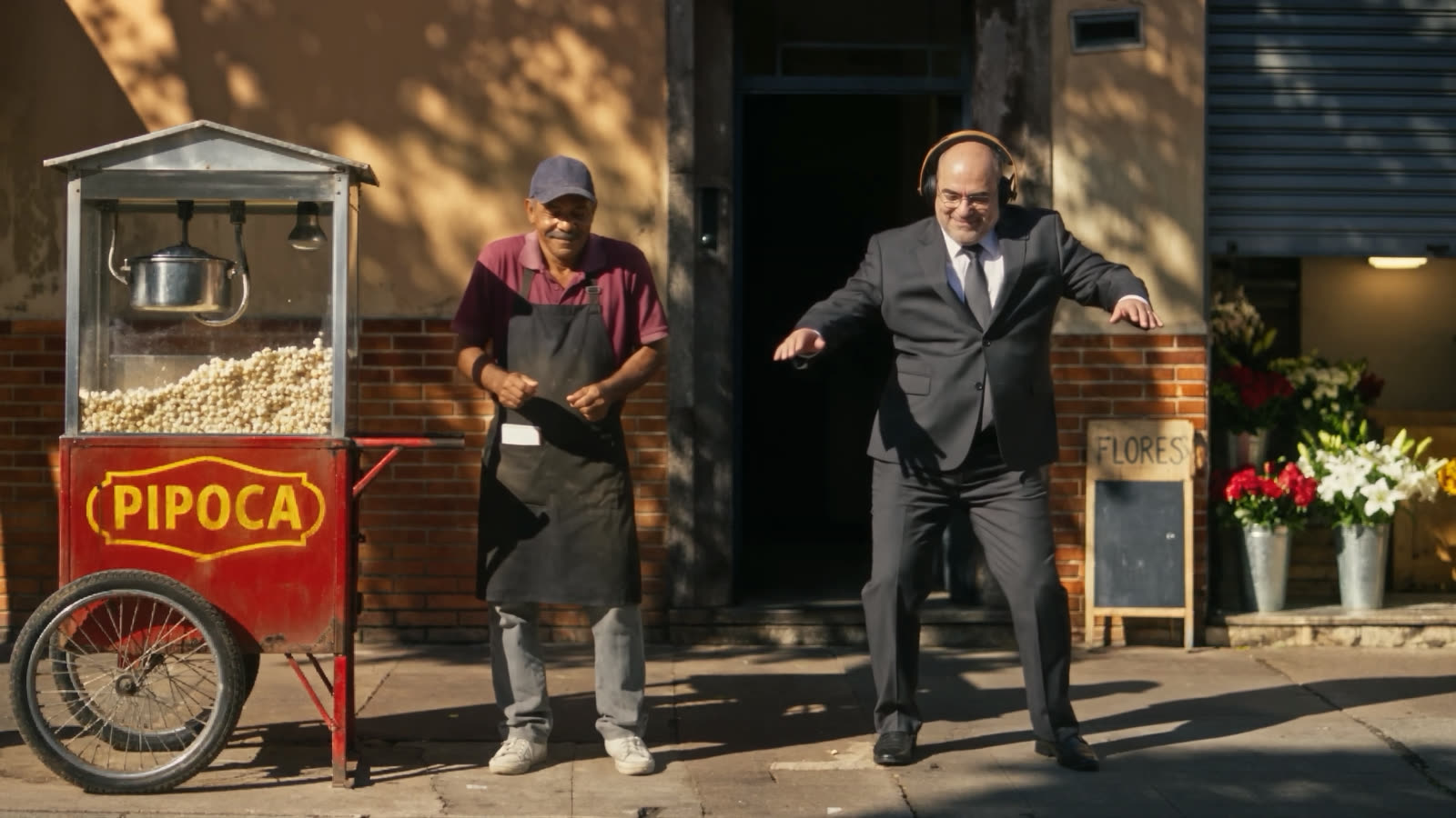 The boss dancing in the street, next to the popcorn cart