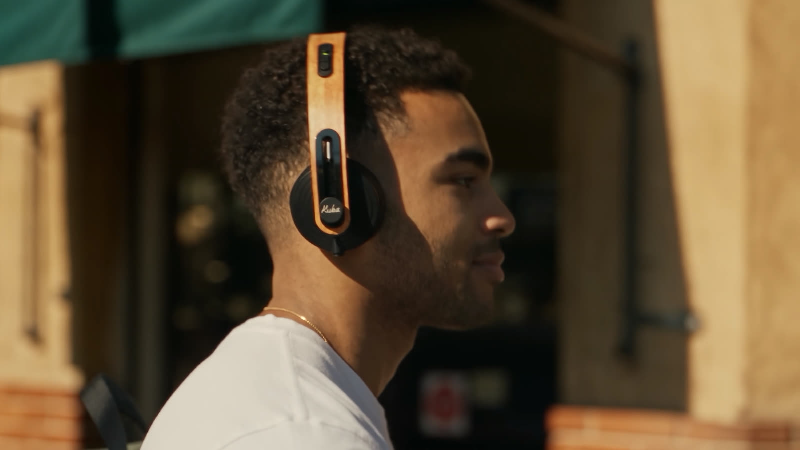His profile with the headphones, in late afternoon light