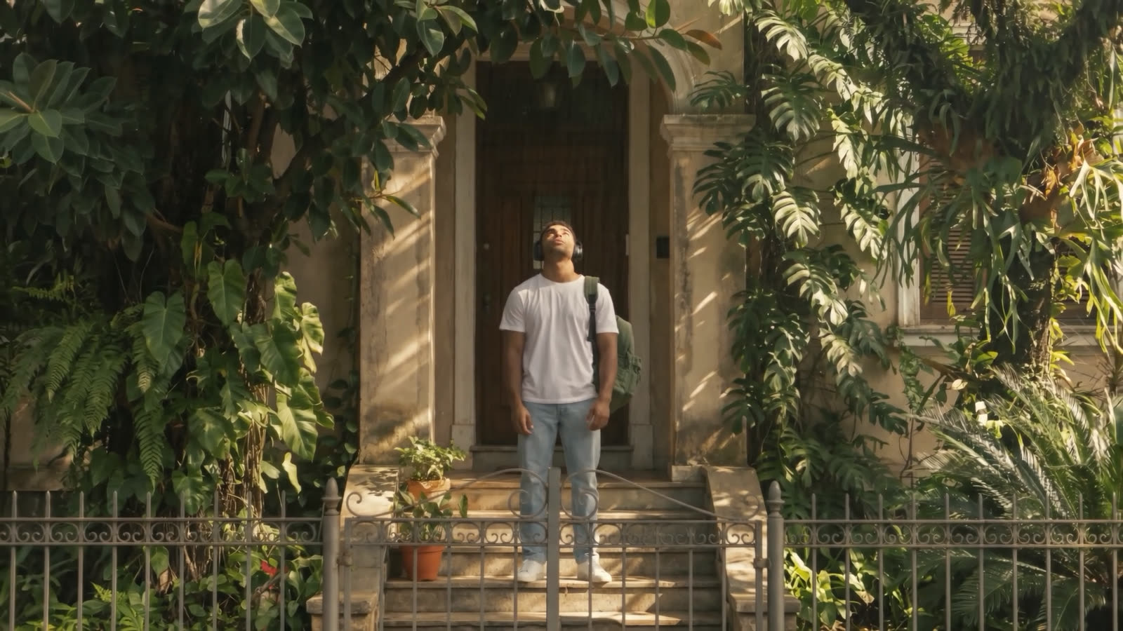 He leaves the house, seen from the pavement