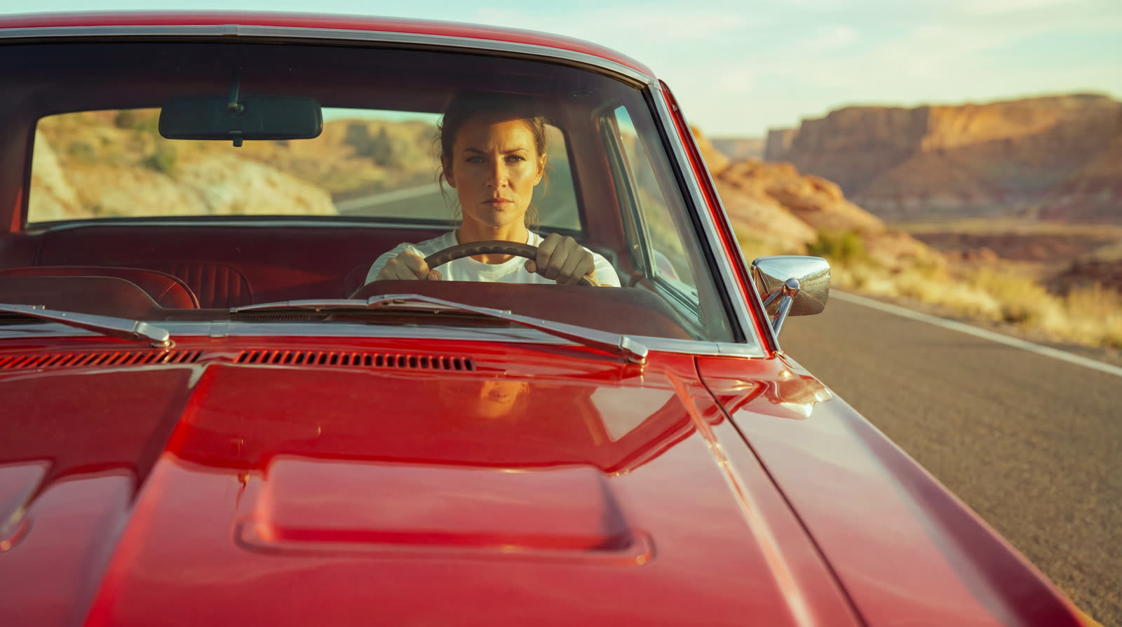 The front of the moving Mustang, the driver at the wheel