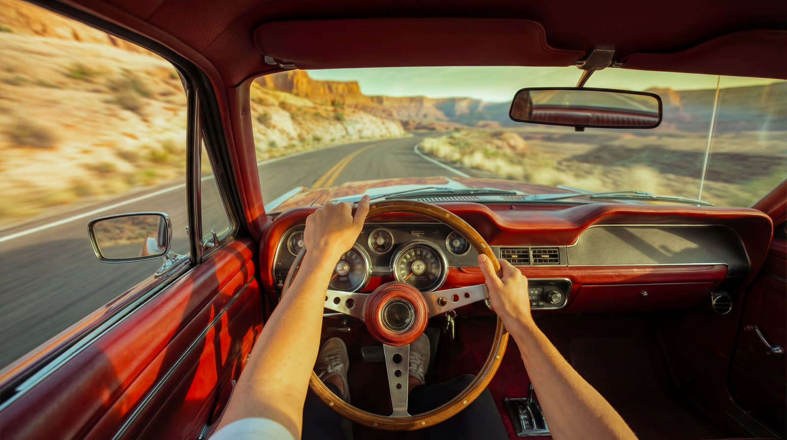 Hands on the wheel, desert road through the windscreen
