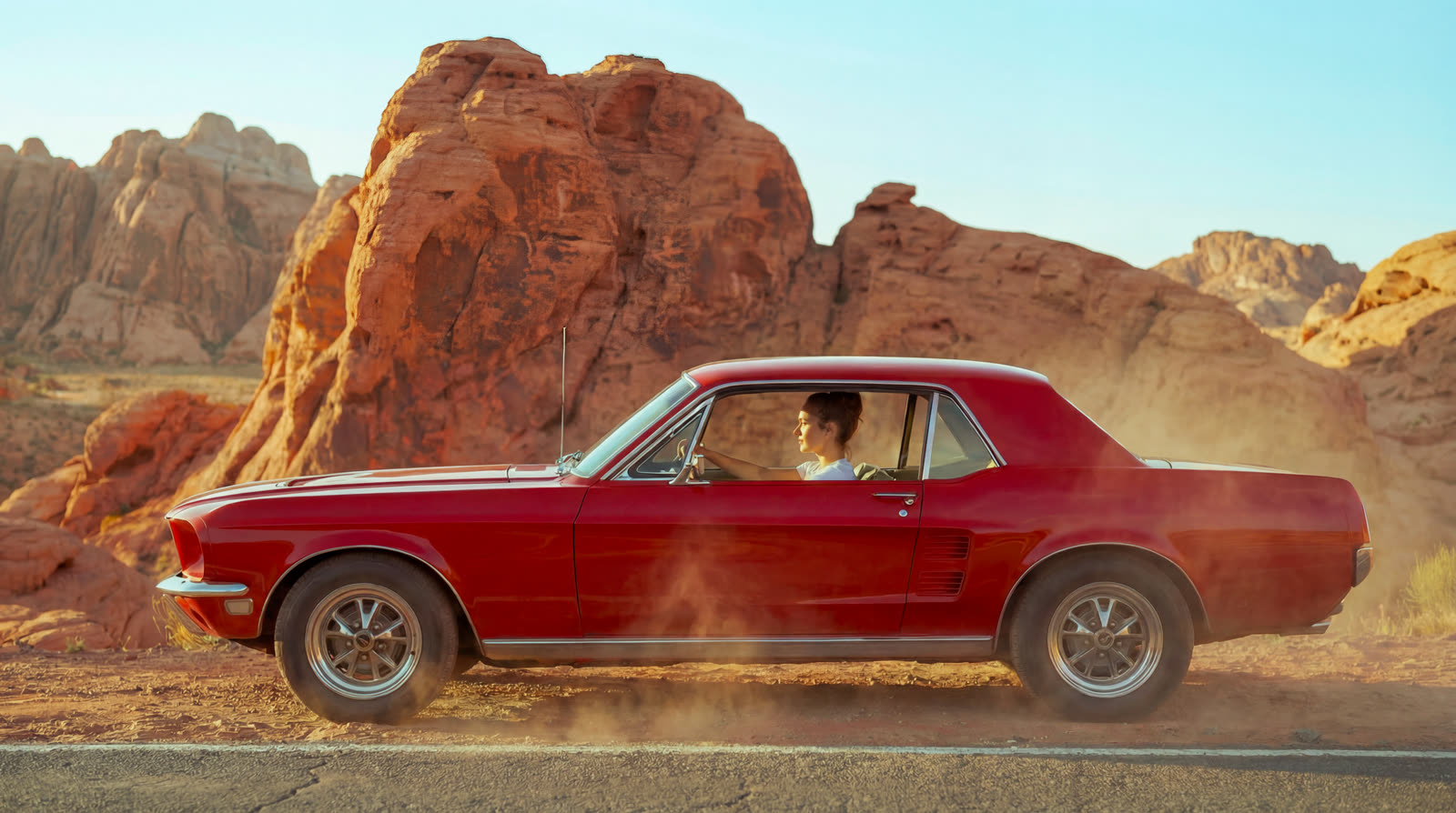 The Mustang parked in profile before a rock formation
