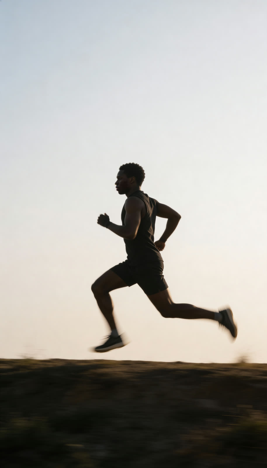 The athlete running in silhouette at dawn